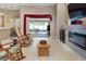 Cozy living room featuring tile flooring, fireplace, and open access to a screened outdoor patio at 11749 Summer Springs Dr, Riverview, FL 33579