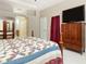 Spacious main bedroom featuring a ceiling fan, tv, and mirrored wardrobe with ample closet space at 11749 Summer Springs Dr, Riverview, FL 33579