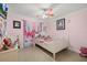 This bedroom features pink walls and a ceiling fan at 12256 Katherwood St, Spring Hill, FL 34608