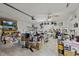 Spacious garage filled with many household items and a mounted television for entertainment and convenience at 12256 Katherwood St, Spring Hill, FL 34608