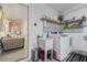 Functional laundry room with modern appliances, shelving and convenient access to the adjacent living area at 12256 Katherwood St, Spring Hill, FL 34608