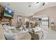 Bright living room features a fireplace, tile floors, plush seating, and an open layout with the kitchen at 12256 Katherwood St, Spring Hill, FL 34608