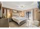 This main bedroom features tile floors, a ceiling fan, and sliding doors to the outdoor patio at 12256 Katherwood St, Spring Hill, FL 34608
