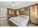 This main bedroom features tile floors, gold accents, and an ensuite bathroom at 12256 Katherwood St, Spring Hill, FL 34608