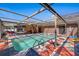 Outdoor pool featuring stylish tiling, ladder access and seamless transition to patio and entertaining space at 12256 Katherwood St, Spring Hill, FL 34608