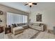 Well-lit living room showcasing a comfortable sectional sofa, stylish rug, and large windows with natural light at 1250 Venetia Dr, Spring Hill, FL 34608