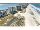 Scenic aerial view showcases a row of oceanfront high-rise condos with beach access, pools, and tennis courts at 1270 Gulf Blvd # 905, Clearwater Beach, FL 33767