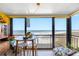 Cozy balcony with dining set overlooking ocean, offering a serene dining or relaxation space at 1270 Gulf Blvd # 905, Clearwater Beach, FL 33767