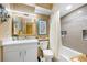 Bathroom featuring a white vanity, a toilet, and a shower-tub with tiled walls at 1270 Gulf Blvd # 905, Clearwater Beach, FL 33767
