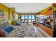 Bedroom featuring a comfortable bed, seating area, and stunning ocean views at 1270 Gulf Blvd # 905, Clearwater Beach, FL 33767
