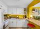 Bright kitchen with white cabinetry, granite countertops and a breakfast bar area at 1270 Gulf Blvd # 905, Clearwater Beach, FL 33767