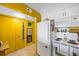 Bright kitchen adjacent to a hallway and featuring modern appliances and ample storage at 1270 Gulf Blvd # 905, Clearwater Beach, FL 33767