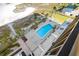 Aerial view of pool and lounge chairs, nestled amongst verdant landscaping near the beach at 1270 Gulf Blvd # 905, Clearwater Beach, FL 33767