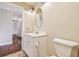 Bathroom featuring a white vanity with a decorative mirror, next to a toilet at 12840 State Road 62, Parrish, FL 34219