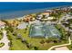Aerial view showcasing community amenities: tennis courts, playground, and waterfront access at 1314 Jumana Loop, Apollo Beach, FL 33572
