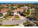 Beautiful home with a circular driveway, manicured lawn, and vibrant landscaping in a desirable neighborhood at 1314 Jumana Loop, Apollo Beach, FL 33572