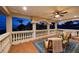 Inviting covered balcony with comfortable seating and picturesque views of lush greenery and the night sky at 1314 Jumana Loop, Apollo Beach, FL 33572
