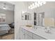 Bright bathroom featuring an inset sink, vanity, and view into an adjacent bedroom at 1314 Jumana Loop, Apollo Beach, FL 33572