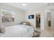 Bright bedroom with a large window and access to a walk-in closet and ensuite bathroom at 1314 Jumana Loop, Apollo Beach, FL 33572