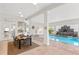 Dining area near the pool with views of the water feature and doors to the outside at 1314 Jumana Loop, Apollo Beach, FL 33572