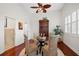 Inviting dining area featuring a glass-topped table, seating for four, with a wine collection and hardwood floors at 1314 Jumana Loop, Apollo Beach, FL 33572