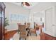 Bright dining room features a round glass table, wood floors, and shuttered windows at 1314 Jumana Loop, Apollo Beach, FL 33572