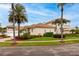 Elegant Mediterranean-style home boasting a tile roof, lush landscaping, and inviting curb appeal under a sunny sky at 1314 Jumana Loop, Apollo Beach, FL 33572