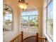 Bright foyer with arched windows offering scenic views and elegant architectural details including a winding staircase at 1314 Jumana Loop, Apollo Beach, FL 33572