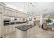 Open kitchen with center island, granite countertops and view of breakfast nook and living area at 1314 Jumana Loop, Apollo Beach, FL 33572