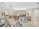 Elegant living room with views of the kitchen, breakfast bar and comfortable seating area at 1314 Jumana Loop, Apollo Beach, FL 33572