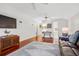 Open living room with wood floors, white walls, ceiling fans, and comfortable seating at 1314 Jumana Loop, Apollo Beach, FL 33572