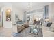 Inviting living room with refined decor, chandelier, and seamless transition to outdoor living at 1314 Jumana Loop, Apollo Beach, FL 33572
