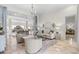 Bright living room with marble floors, elegant furnishings, chandelier, and access to the pool area at 1314 Jumana Loop, Apollo Beach, FL 33572