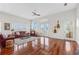 Bright living room with hardwood floors, a ceiling fan, and French doors leading to the outside at 1314 Jumana Loop, Apollo Beach, FL 33572