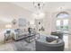 Well-lit living room featuring neutral tones, elegant furnishings, chandelier, and marble floors at 1314 Jumana Loop, Apollo Beach, FL 33572