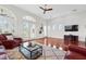 Spacious living area with high ceilings, wood floors, and access to outdoor balcony at 1314 Jumana Loop, Apollo Beach, FL 33572