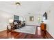 Bright living room with hardwood floors, ceiling fans, and French doors to the balcony at 1314 Jumana Loop, Apollo Beach, FL 33572