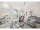 Spacious living area with elegant decor, seamless transition to adjacent rooms, and luxurious finishes at 1314 Jumana Loop, Apollo Beach, FL 33572