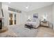 Bright main bedroom featuring a sitting area, fireplace, and French doors leading to the outside at 1314 Jumana Loop, Apollo Beach, FL 33572