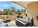 Covered patio featuring wicker furniture and a modern fire pit overlooking a lush, landscaped yard at 1314 Jumana Loop, Apollo Beach, FL 33572