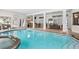 Bright indoor pool and spa with seating and dining areas just beyond at 1314 Jumana Loop, Apollo Beach, FL 33572