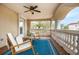 Charming covered porch featuring rocking chairs, a ceiling fan, and neighborhood views at 1314 Jumana Loop, Apollo Beach, FL 33572