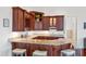 A beautiful wet bar featuring custom cabinetry, granite countertops, and seating for three at 1314 Jumana Loop, Apollo Beach, FL 33572