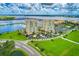 Exceptional aerial view of two luxury high-rise towers, showcasing meticulously landscaped grounds and waterfront views at 140 Riviera Dunes Way # 404, Palmetto, FL 34221