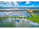 Gorgeous aerial view of waterfront property with numerous boat docks, picturesque landscaping, and tranquil open water views at 140 Riviera Dunes Way # 404, Palmetto, FL 34221