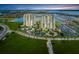 Stunning aerial view of the condominium towers, lush landscaping, boat marina and surrounding bay waters at 140 Riviera Dunes Way # 404, Palmetto, FL 34221