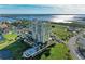 Stunning aerial view of a high-rise condo, showcasing manicured grounds, pool, and scenic waterfront views at 140 Riviera Dunes Way # 404, Palmetto, FL 34221