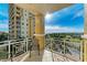 Scenic balcony with glass railings providing stunning water views and overlooking lush greenery at 140 Riviera Dunes Way # 404, Palmetto, FL 34221