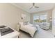 Comfortable bedroom features a ceiling fan, a large window and work desk at 140 Riviera Dunes Way # 404, Palmetto, FL 34221