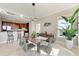 Dining room with modern lighting fixture and furniture near a kitchen with bar seating at 140 Riviera Dunes Way # 404, Palmetto, FL 34221